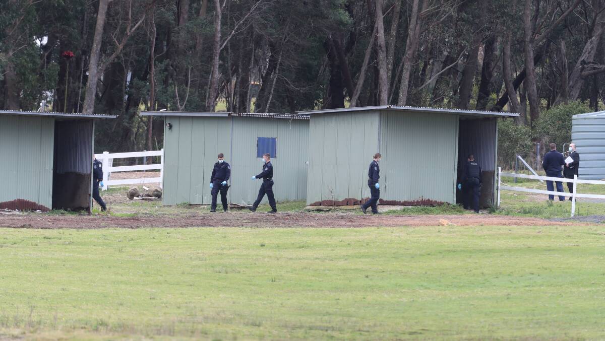 Police search outbuildings at the Helensburgh property on Wednesday. Picture: Robert Peet 