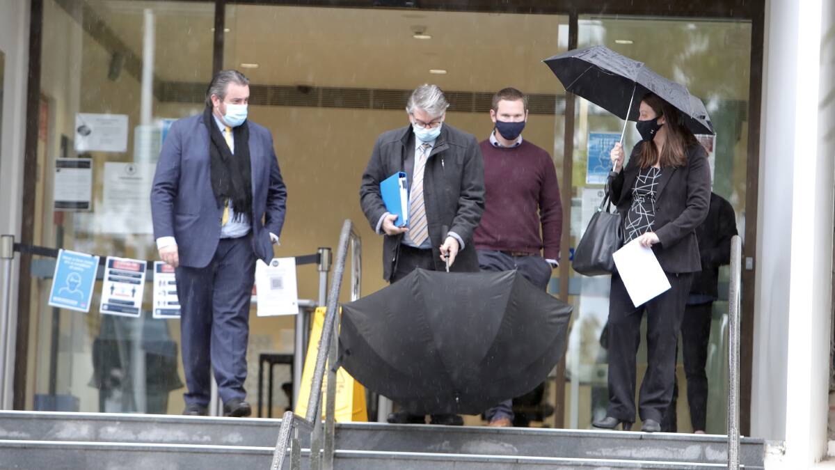 Supporters including Mr Horsley's colleagues and son-in-law Ryan Shepherd (marone jumper) depart the courthouse on Tuesday. 