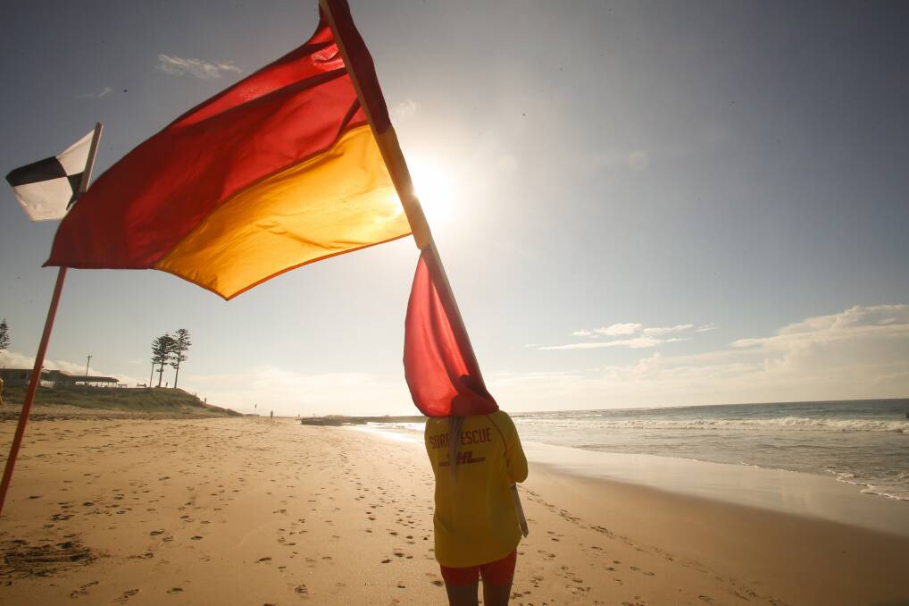 FLAGS DOWN: Bulli beach volunteer lifesaver Kaimana Fittock prepares to farewell the 2017/2018 patrol season, which ends on Sunday. Picture: Georgia Matts