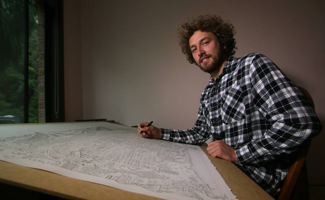 Thirroul cartographer Alex Pescud continues work on his A0-sized hand-drawn map of Wollongong. Picture: Sylvia Liber 