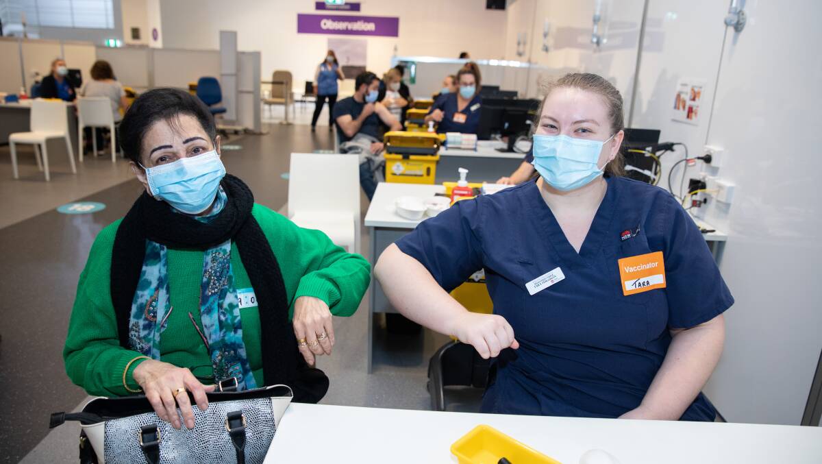 Cordeaux Heights; Sheila Samtani shares an elbow bump with "vaccinator" Tara after receiving her first Pfizer faccine at Wollongong's new vaccine hub on Monday. Picture: supplied 