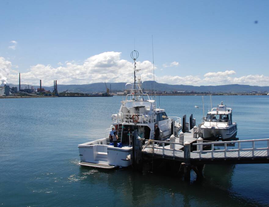 Water police return the man's body to land at Port Kembla, Tuesday afternoon.