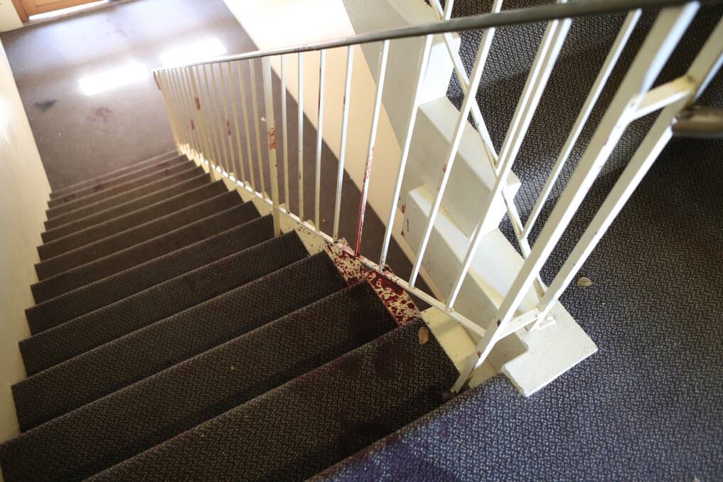 Bloodstains in the stairwell show the injured man's path. Picture: Robert Peet 