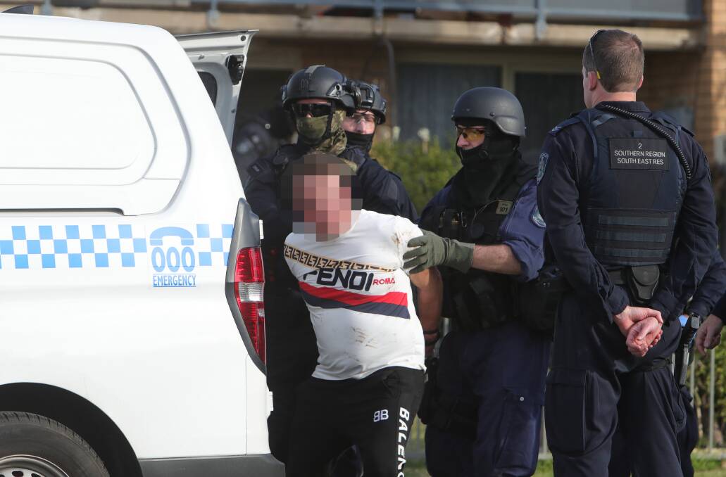 The man wore a tormented expression as he was taken into custody. Picture: Sylvia Liber 