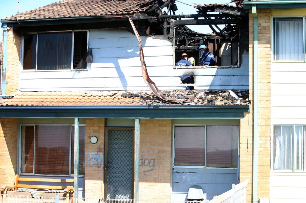 Firefighters inspect the badly damaged upper floor of the Whitby Mews townhouse. Pictures: Sylvia Liber 