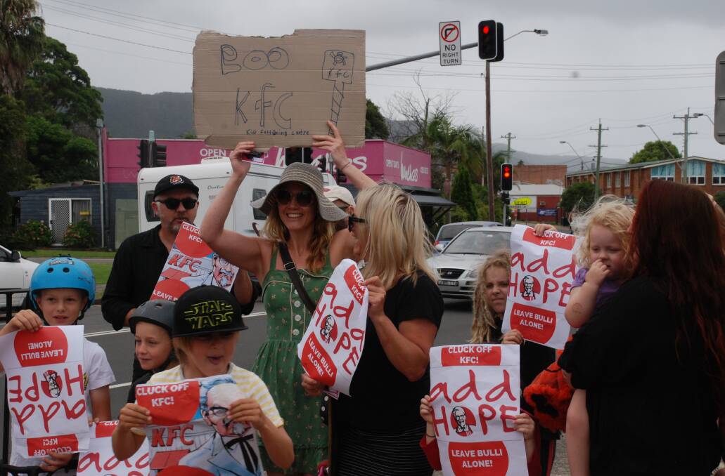 Opponents of a proposal to build a KFC restaurant at Bulli stage a rally beside the Princes Highway development site on Thursday. Pictures: Angela Thompson