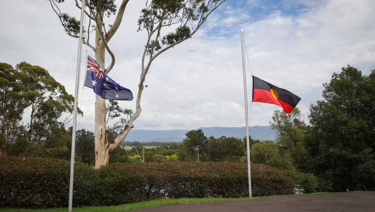 Australain and Aboriginal flags fly at half mast at Monday's service. 