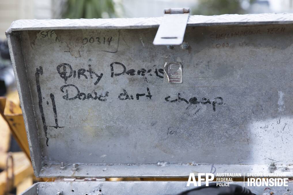A handwritten message on a case found during Sunday's raid at West Wollongong. Picture: AFP 