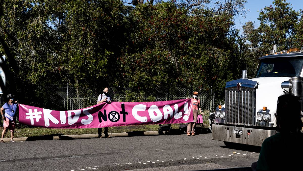 Protesters cross paths with a departing truck at the Russell Vale colliery on Monday. Picture: supplied 