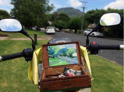 Richard Claremont created a "mobile plein air studio" from an old cigar box propped up on his postal delivery bike. 