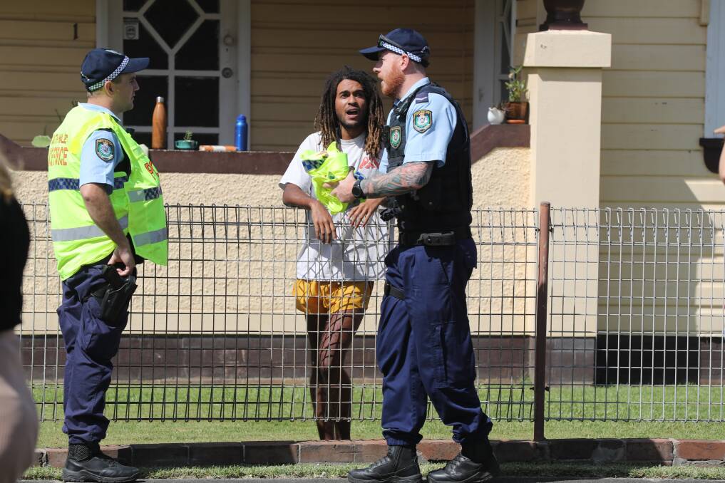 Resident Kyle Smith speaks to police in the aftermath of the crash. Picture: Robert Peet 