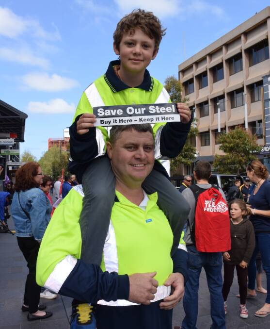 BROAD SHOULDERS: Bluescope employee Simon O'Connor and his son Jaryn, 10, don matching high-vis shirts for Saturday's steel rally. Picture: Angela Thompson
