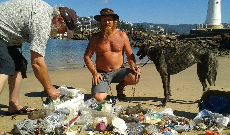 TRASHED: Seabird specialist Lindsay Smith examines a pile of plastic waste collected by Glen Mitchell from a remote beach in the Royal National Park. Picture: supplied