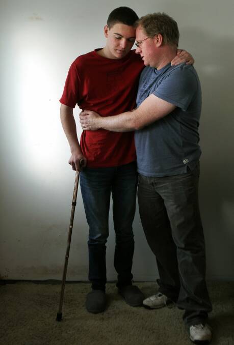 SUFFERING: Ben Oakley is supported by his father Michael in this May, 2015 photo. He credits cannabis oil with easing his suffering and allowing him to live more independently.  Picture: Sylvia Liber
