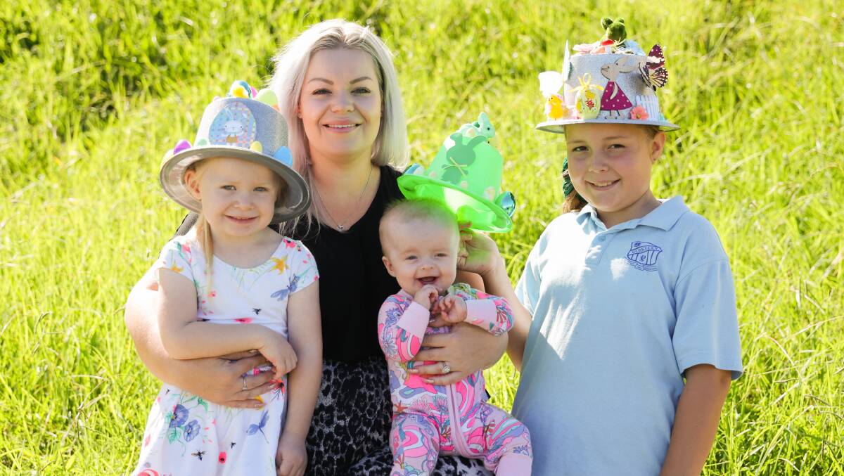Ms Vudmaska with hats modelled by her children Violet, Imogen and Azahli. Picture: Wesley Lonergan 