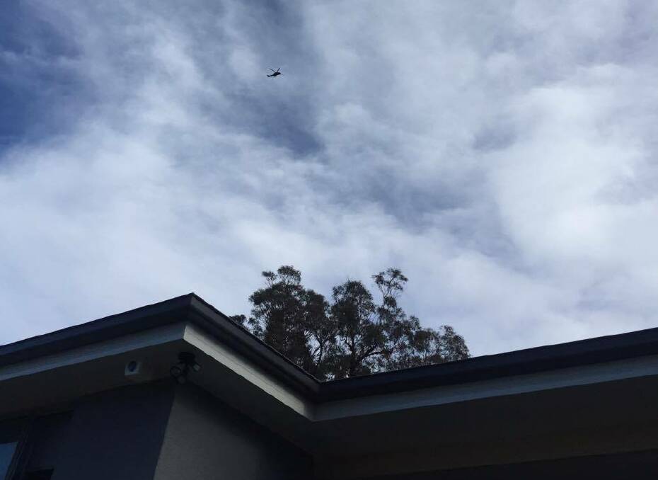A Polair chopper searches Warilla from the sky, Thursday afternoon. Picture: Alexis Paule 