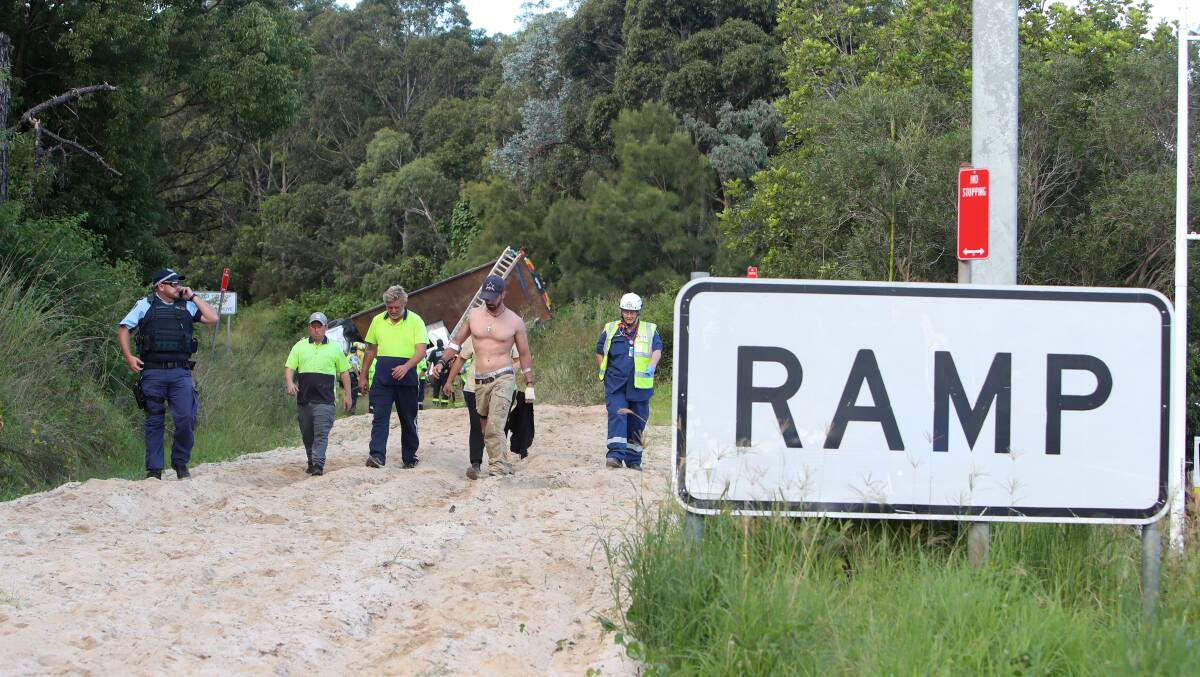 Emergency service workers and the truck driver at the March 28 incident. Picture: Sylvia Liber 