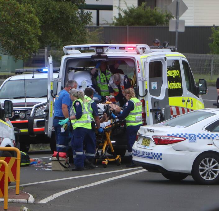 Paramedics assist the man injured in Thursday's crash. Pictures: Sylvia Liber 