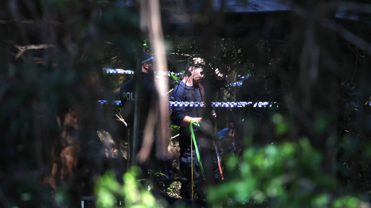 A crime scene officer at work in bushland at Mount Kembla on Thursday, September 28. Picture: Sylvia Liber 