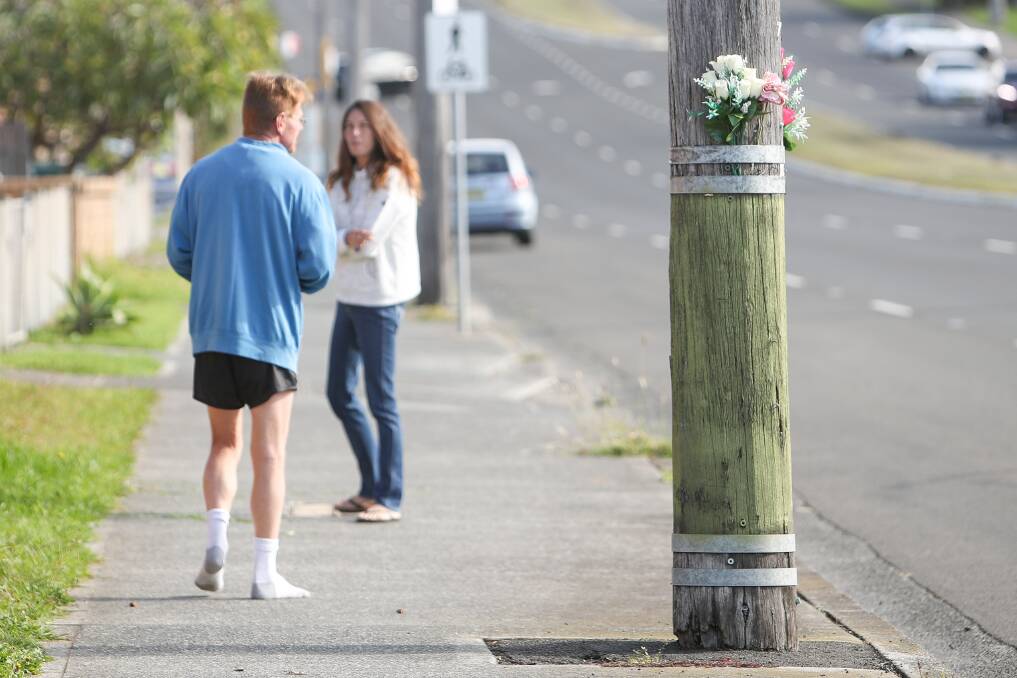 A floral tribute marks the site of a past fatality on Lake Entrance Road. Picture: Adam McLean 