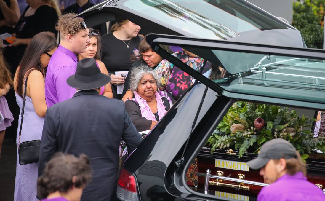 Aunty Lorraine Brown is flanked by supporters at Monday's funeral service. Pictures: Wesley Lonergan