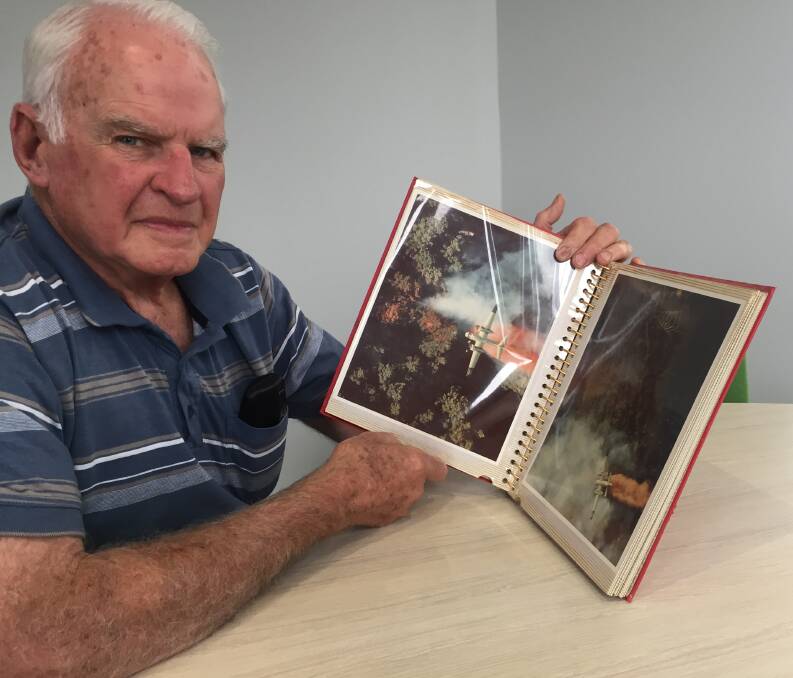 Early days of aerial firefights: Former Ballarat MLA Paul Jenkins with an image of a US fire bomber in action. Mr Jenkins helped introduce aerial firefighting in Victoria after a long career at Sebastopol FB. Picture: Caleb Cluff.
