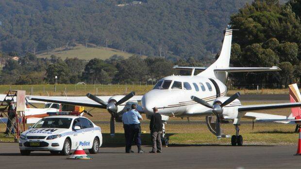 Police examine the twin-engine turbo-prop Swearingen Merlin 3 eight-seater at Illawarra Regional Airport on July 9, 2014.  Picture: Kirk Gilmour

