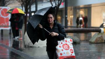 A shopper braces the deluge in Wollongong CBD. Picture: Sylvia Liber