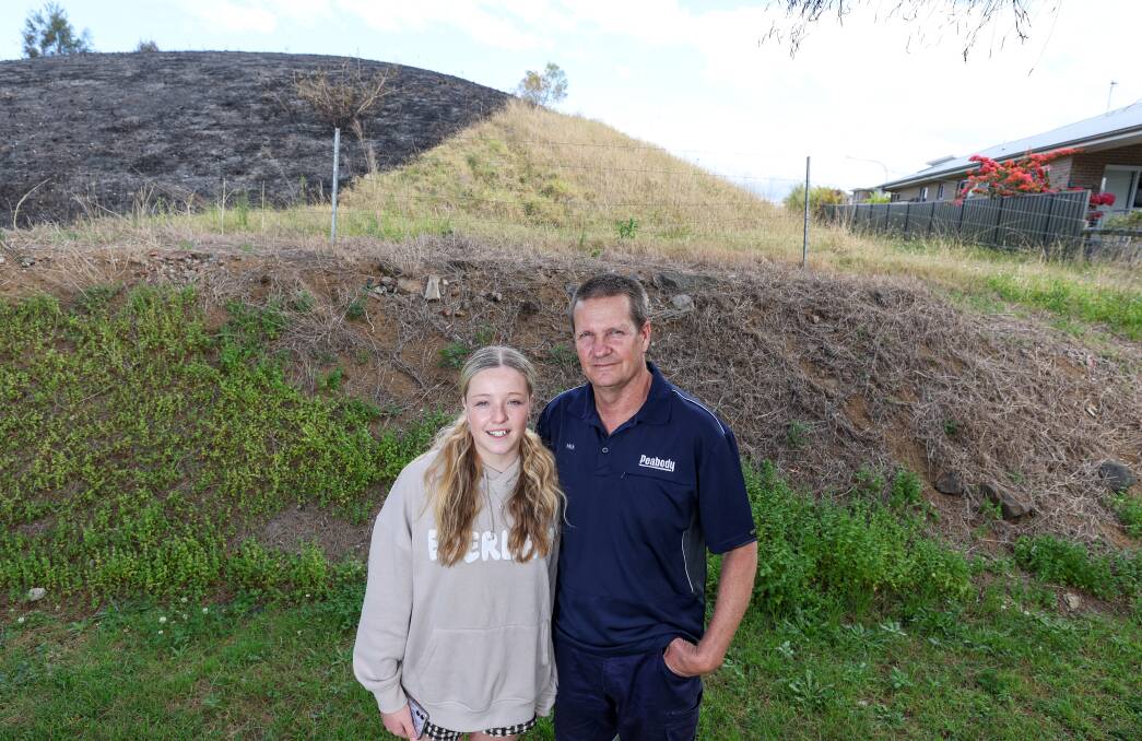 Photo shows Mick Coan with his daughter Tahlia (14). Mick helped save his neighbour's house from the flames of a grass fire in Kanahooka. Picture by Adam McLean
