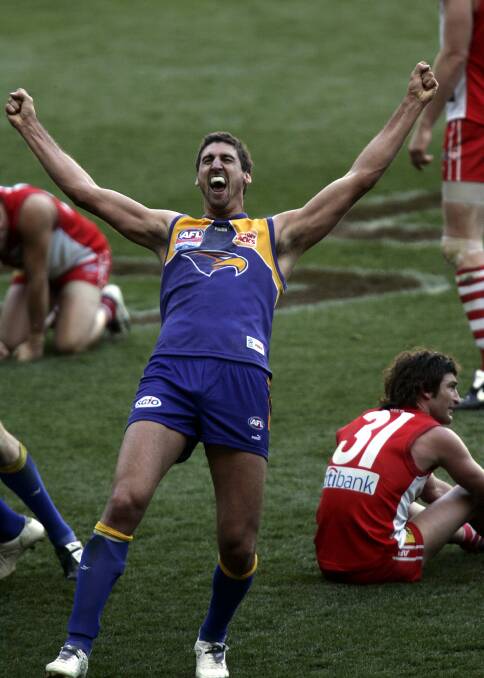 A Canadian pub with the sound off: Dean Cox celebrates as the full-time siren sounds in the 2006 AFL grand final against Sydney. The Eagles won by a point, after losing the 2005 decider to the Swans by four. Picture: Ken Irwin