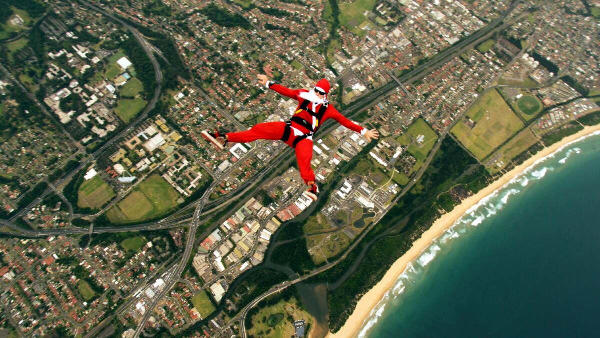 Santa skydiving into Wollongong to launch the Santa Pub Crawl in 2009.  Picture: Kip Frost