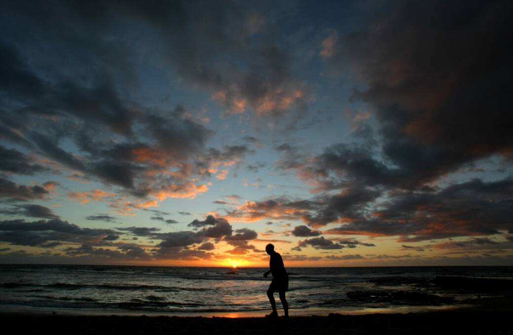 DAILY RITUAL: Keith Woodward at dawn on Austinmer beach, before his morning swim. He did it every day, regardless of weather or season. Picture: Kirk Gilmour