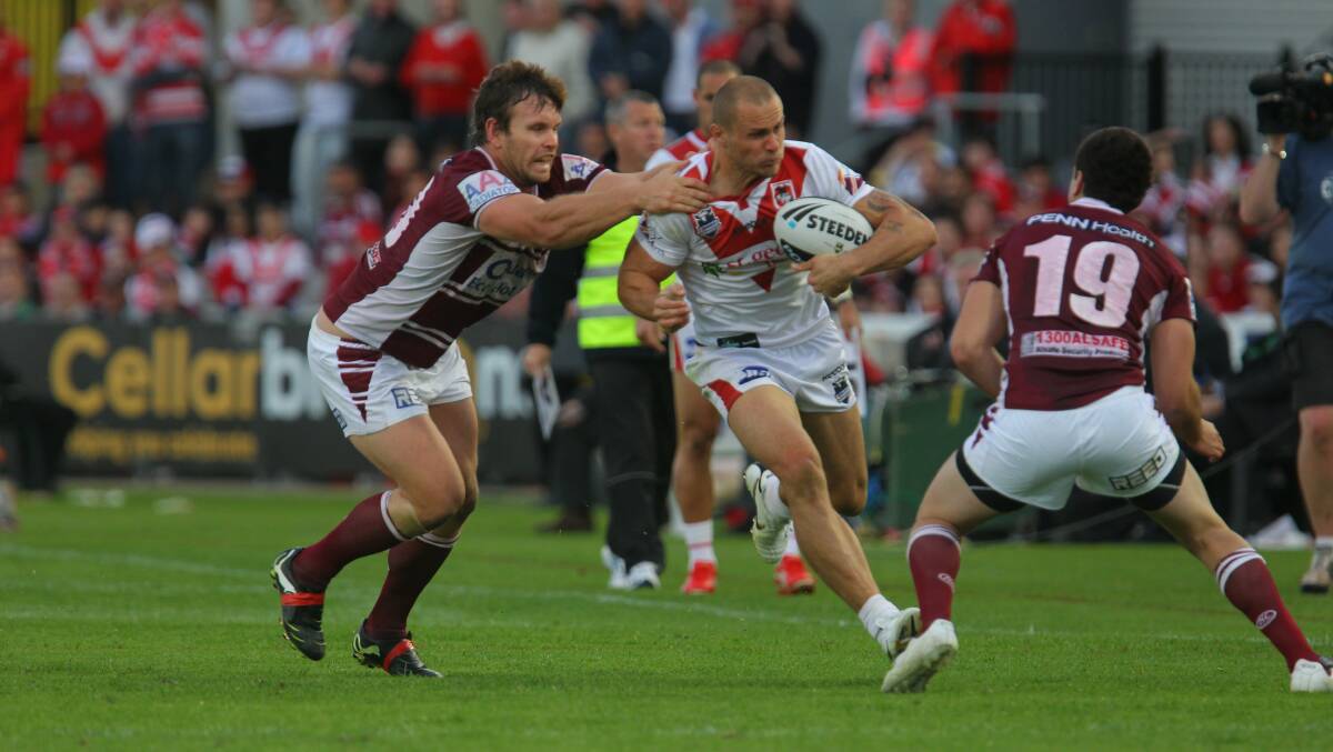 Breaking through: Matt Cooper takes on the Manly defensive line in the 2010 final. Picture: David Tease.