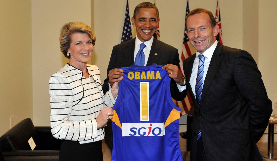Flying high: Former US president Barack Obama (centre) with Julie Bishop and Tony Abbott and a West Coast Eagles guernsey in 2011. Could we see Obama in Illawarra Hawks colours? Picture: The Age