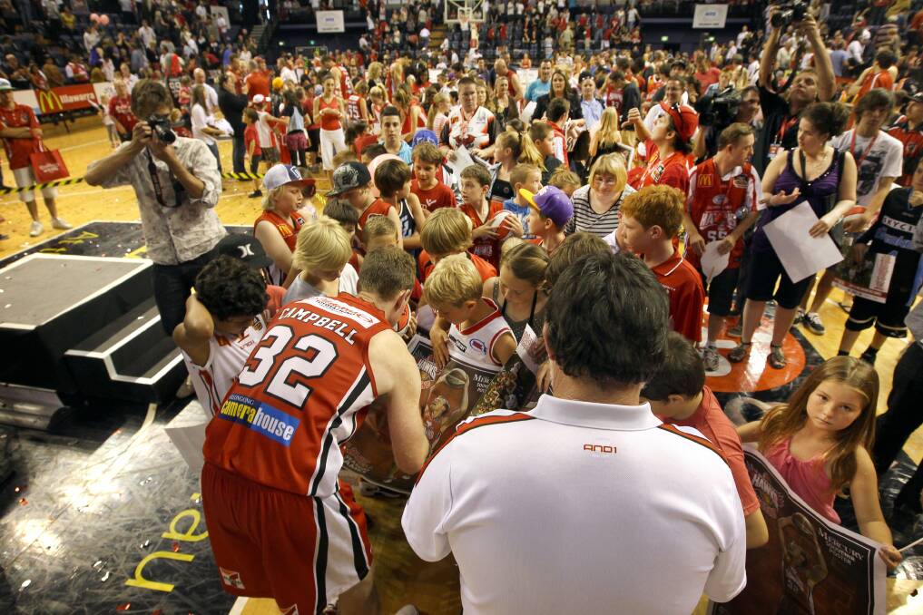 YOUR TRIBE: Hawks captain Mat Campbell swamped by autograph hunters after his last game, March 2012. Picture: SYLVIE LIBER.