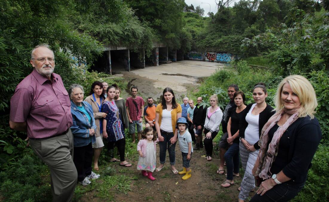 HIGH AND DRY: Residents of the Northview Estate at Figtree at the culverts where American Creek passes under the M1. They want an immediate fix to their troubles with 'phantom floods'. Picture: Sylvia Liber.