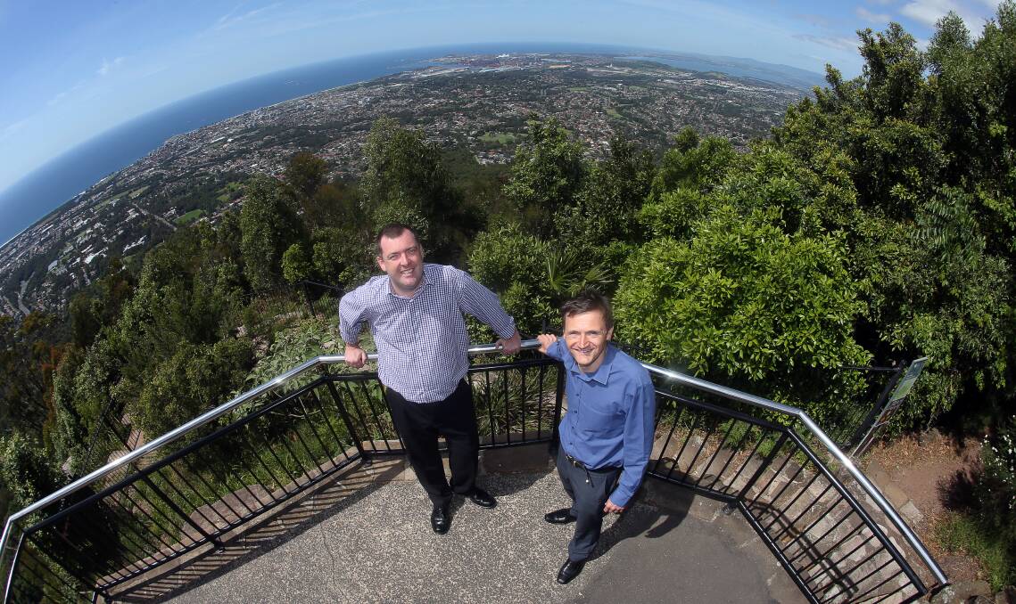 UP TOP: Destination Wollongong general manager Mark Sleigh (left) at the Mt Keira lookout.