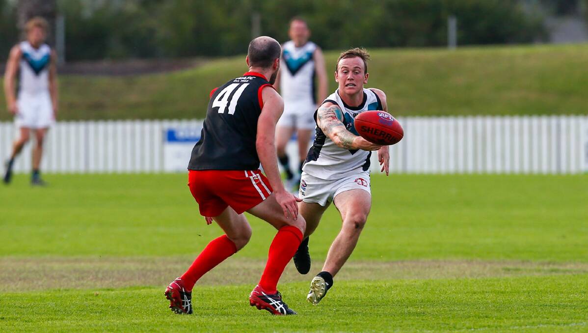 Battle: Kiama player Jimmy Ryan tries to gather in possession against the Lions last year. Picture: Adam McLean