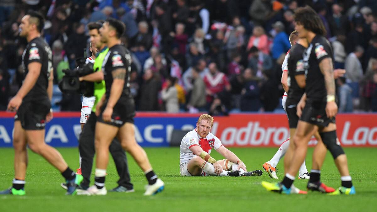 England's James Graham sits dejected amongst New Zealand players at the end of their Four Nations semi-final last year. Picture: Dave Howarth / PA via AP