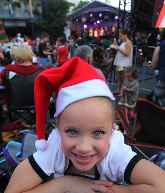 To all a good night: Melody Mihajlovic from Berkeley was all smiles at Carols on Crown on Saturday evening. The eight-year-old was one of thousands who attended on the night.  Picture: Robert Peet