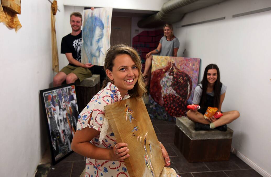 FOOT IN THE DOOR: Andrew Clay, Greer Harris, Renae MacAlpine and Bernadette Banasik all set for their exhibition in Globe Lane. Banasik holds bags of sugar for her toffee sculptures, designed to melt during the exhibition. Picture: Robert Peet