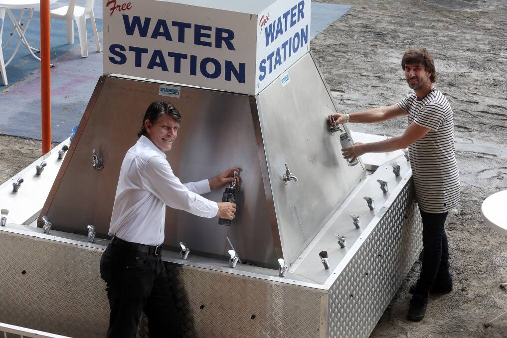 Sydney Water's Peter Hadfield and David De Santi at one of the free water points ready for the Illawarra Folk Festival this weekend. Picture: Robert Peet