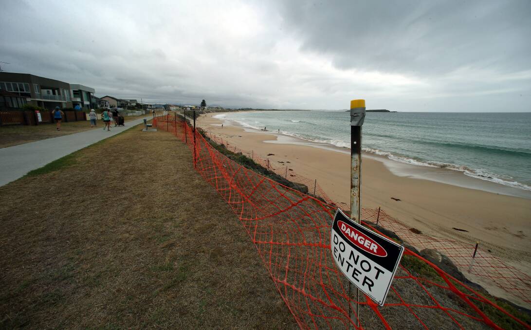 No entry: A section of Warilla beach sea wall has been blocked off after council consultants discovered bonded asbestos in building material stuck in some of the crevices a week ago. Picture: Sylvia Liber
