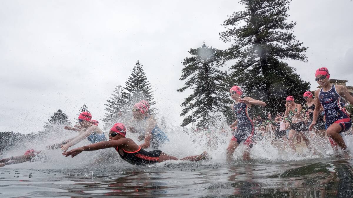 BIG SPLASH: Youngsters dive in during the Aquathon events on Australia Day at Wollongong Harbour. 