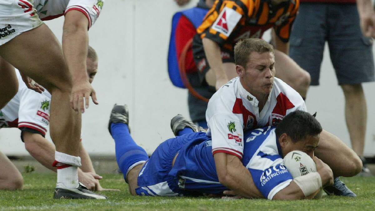 Try time: Bulldogs centre Willie Talau scores against the Dragons in 2002. Picture: Mark Nolan/Getty Images