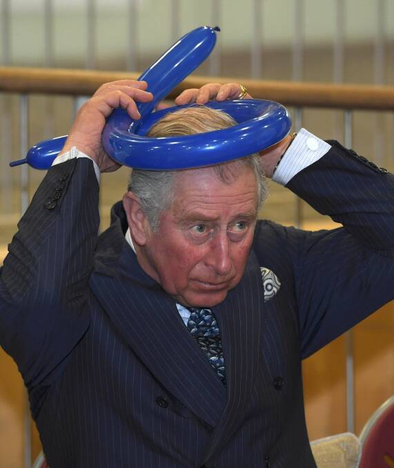 If the crown fits: Prince Charles has a joke with a balloon earlier this month