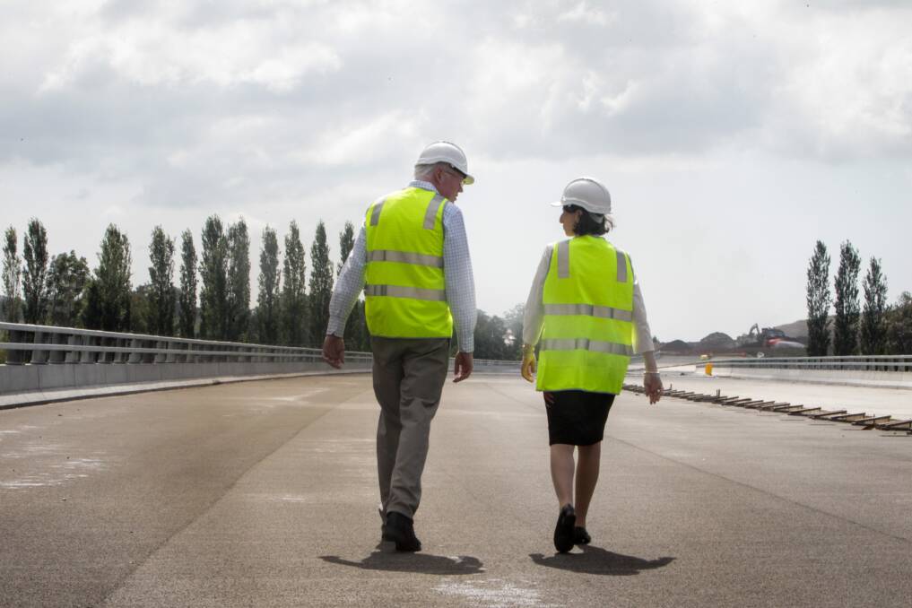 Kiama MP Gareth Ward and NSW Premier Gladys Berejiklian walking along the Berry bypass earlier this year. Fulton Hogan, who built the bypass, has made the shortlist to construct both the Berry to Bomaderry Princes Highway upgrade and the Albion Park Rail Bypass. Picture: Georgia Matts