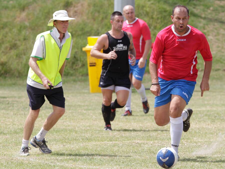 RED RUN: Liverpool player Milan Savic against Jamberoo Pub during the Johnny Warren Cup.