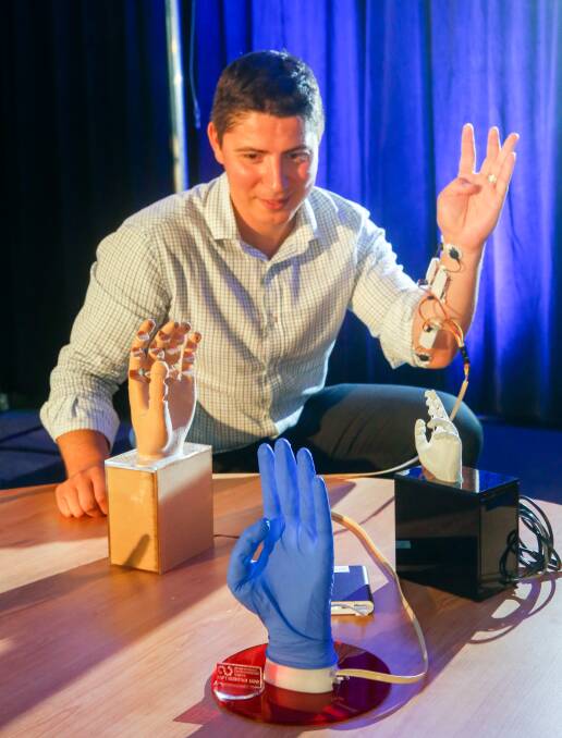 Helping hand: ACES Research Fellow Dr Rahim Mutlu demonstrates the functionality of the new soft robotic hand developed by a UOW team. Picture: Adam McLean 