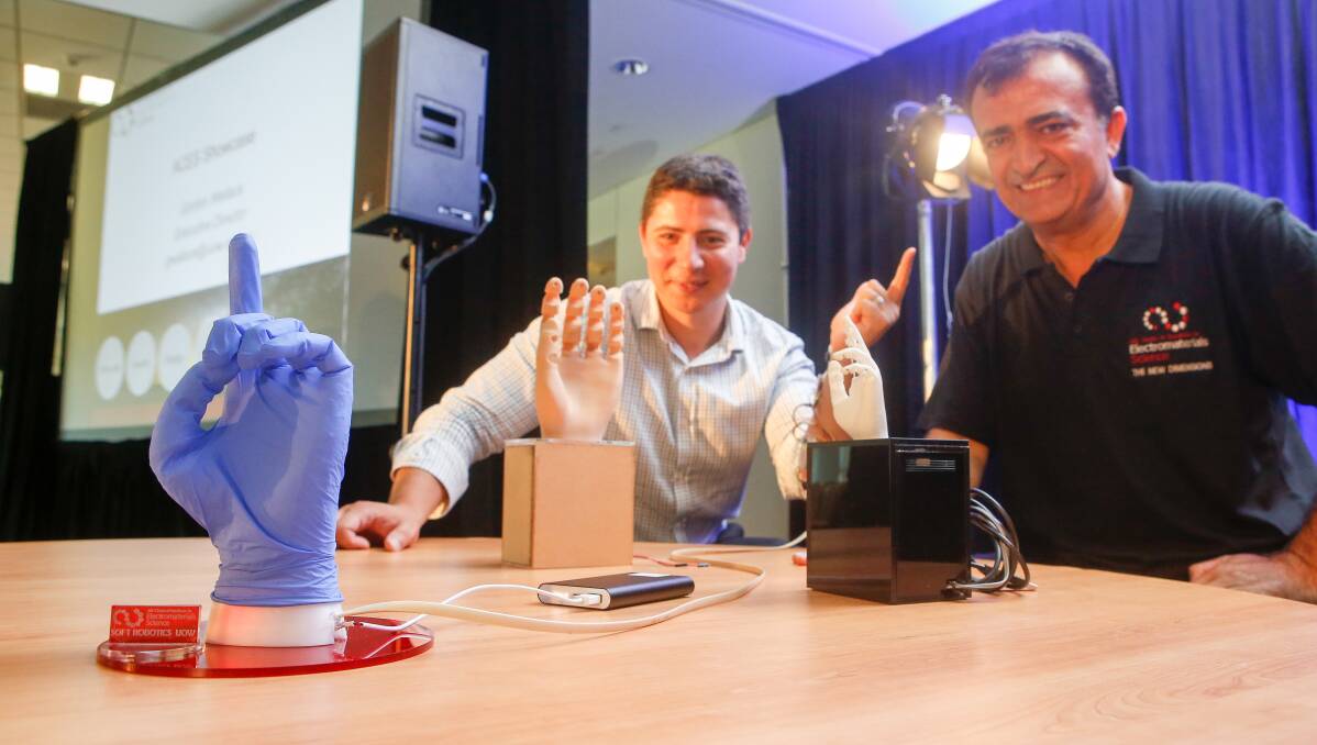 Dr Rahim Mutlu and Professor Gursel Alici with the soft robotic hand which is lightweight, low-cost and enables users to make more lifelike movements. Picture: Adam McLean 